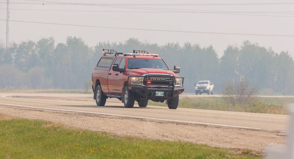 MIKE DEAL / FREE PRESS
Emergency vehicles leave the closed zone on Lee River Road, Wednesday.