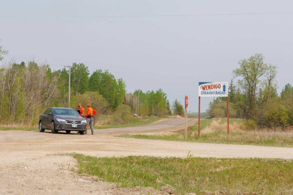 MIKE DEAL / FREE PRESS
     Police officers block the road at Wendigo Road and Old Pointe Road, Wednesday.