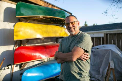 BROOK JONES/FREE PRESS Paddle and Hum owner Myron Sawatzky builds lightweight solo canoes in a backyard shed he converted into his workshop. The 49-year-old is pictured standing in front of Soupspoon and Freeboard shaped fiberglass canoes he built in his North Kildonan backyard workshop in Winnipeg, Man., Monday, May 5, 2025. The canoes feature a free hanging seat.
                                BROOK JONES / FREE PRESS
                                Paddle and Hum owner Myron Sawatzky crafts his lightweight solo canoes in a converted shed in his North Kildonan backyard.
