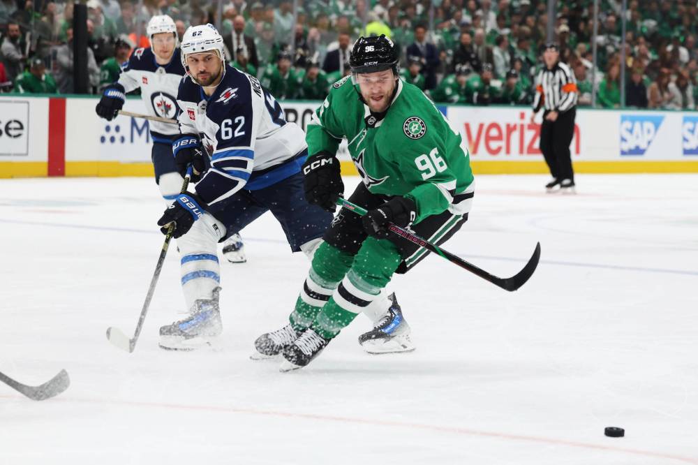 Gareth Patterson / The Associated Press
Dallas Stars right wing Mikko Rantanen and Winnipeg Jets right wing Nino Niederreiter compete for control of the puck in the first period.