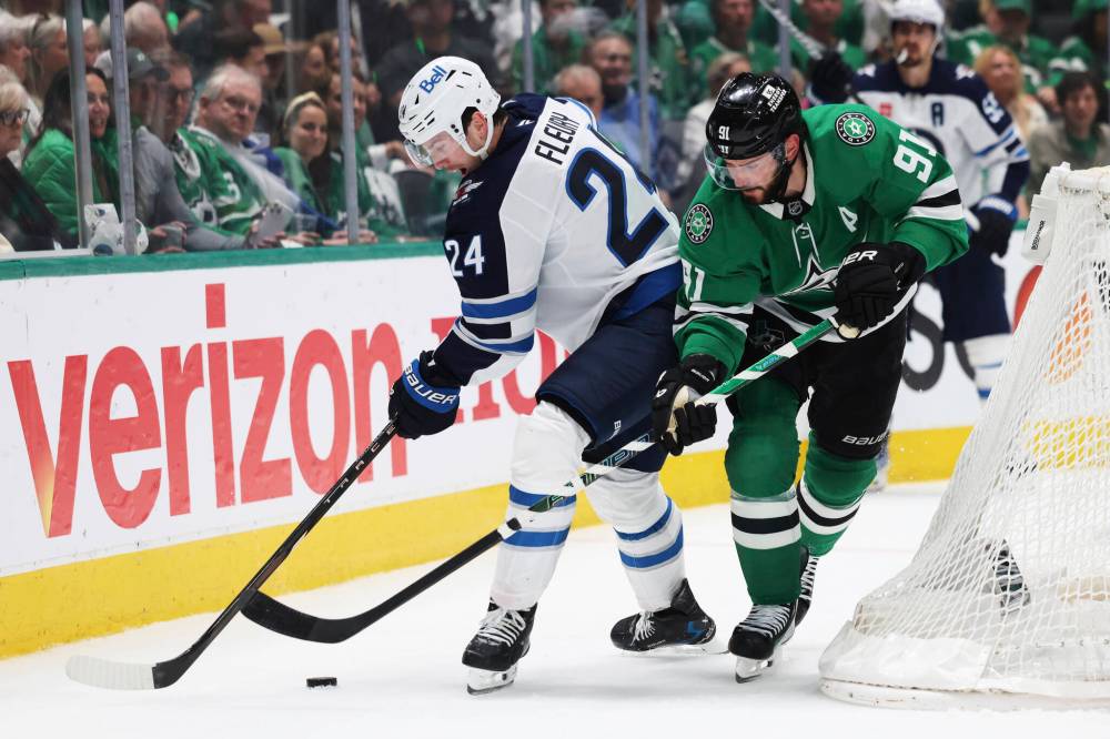Gareth Patterson / The Associated Press
Winnipeg Jets defenceman Haydn Fleury and Dallas Stars centre Tyler Seguin battle behind the Jets’ net in the first period.