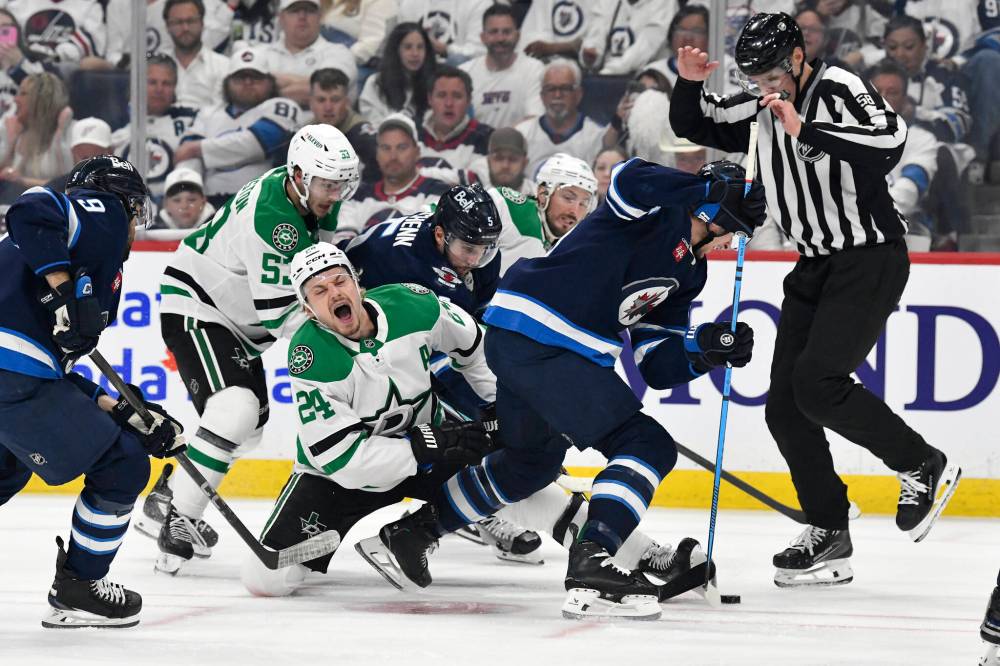 Fred Greenslade / CANADIAN PRESS
Dallas Stars’ Roope Hintz grimaces after a face-off against Winnipeg Jets’ Morgan Barron in the first period.
