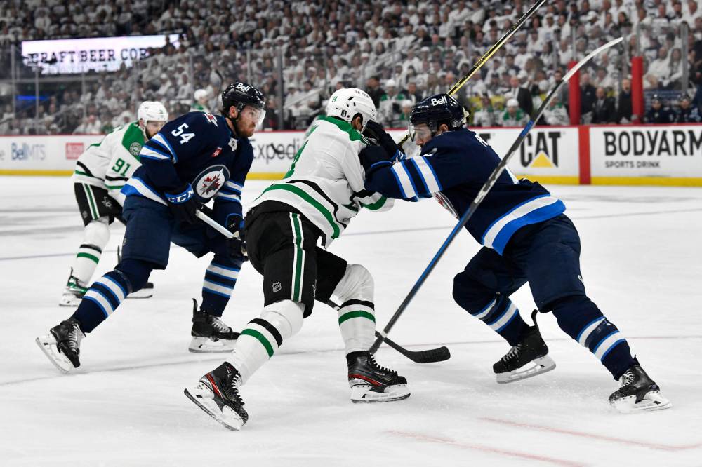 Fred Greenslade / CANADIAN PRESS
Winnipeg Jets’ Neal Pionk checks Dallas Stars’ Jamie Benn in the first period.