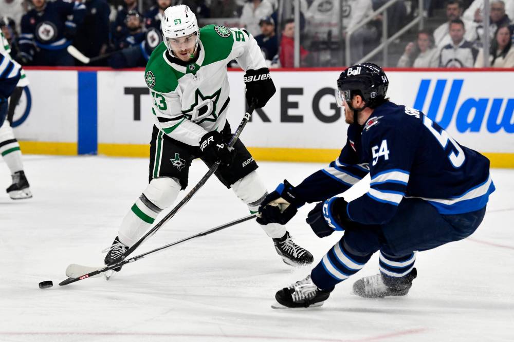 Fred Greenslade / CANADIAN PRESS
Winnipeg Jets defenceman Dylan Samberg knocks the puck away from Dallas Stars’ Wyatt Johnston in the first period.
