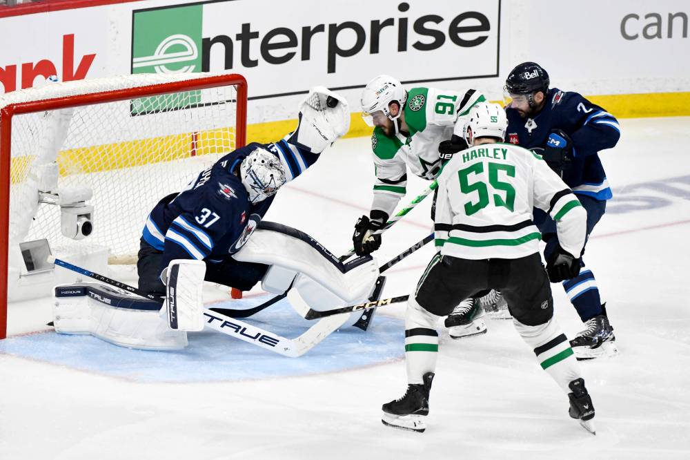 Fred Greenslade / CANADIAN PRESS
Jets goalie Connor Hellebuyck flashes the leather to make an outstanding save against the Dallas Stars in second-period action Thursday at Canada Life Centre.