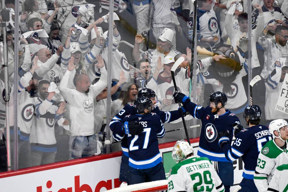 Fans cheer on May 9 as Winnipeg Jets’ Gabriel Vilardi (13) celebrates his goal against the Dallas Stars with Nikolaj Ehlers (27) and Kyle Connor (81) in Winnipeg. (Fred Greenslade / The Canadian Press files)