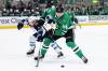 Winnipeg Jets defenseman Neal Pionk (4) and Dallas Stars center Roope Hintz (24) compete for control of the puck in the first period of Saturday’s game. The Stars won 2-1 in overtime. (Gareth Patterson / The Associated Press)