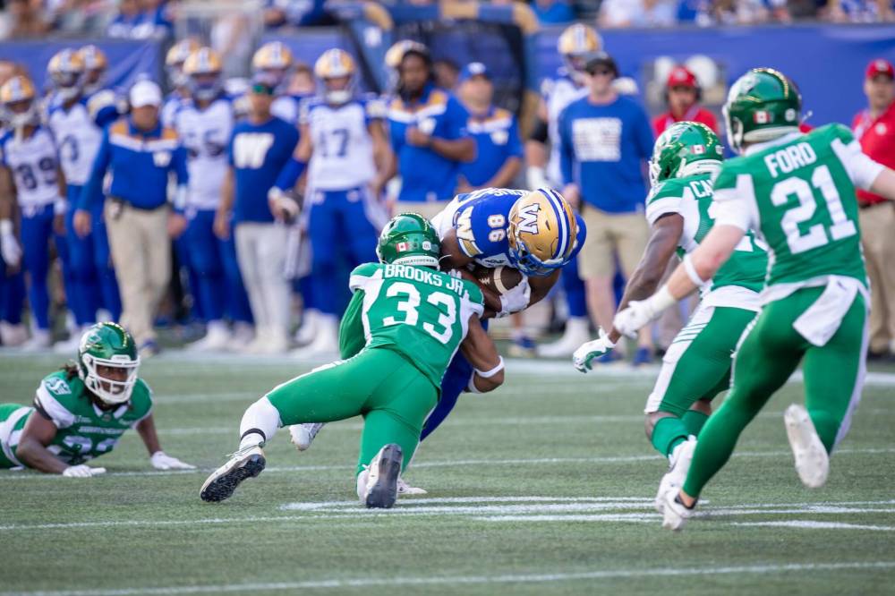 BROOK JONES/FREE PRESS The Winnipeg Blue Bombers host the visiting Saskatchewan Roughriders in Canadian Football league preseason action at Princess Auto Stadium in Winnipeg, Man., Saturday, May 24, 2025. The Bombers earned a 15-9 victory over the Riders. Pictured: Bombers wide receiver Kevens Clercius (No. 86) is tackled by Riders linebacker Antonie Brooks Jr. during first quarter action.