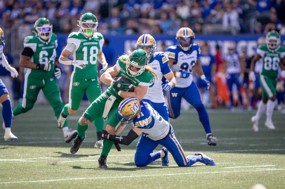 BROOK JONES/FREE PRESS The Winnipeg Blue Bombers host the visiting Saskatchewan Roughriders in Canadian Football league preseason action at Princess Auto Stadium in Winnipeg, Man., Saturday, May 24, 2025. The Bombers earned a 15-9 victory over the Riders. Pictured: Bombers defensive back Evan Holm (No. 31) tackles Riders running back A.J. Ouellette (No. 45) during second quarter action.