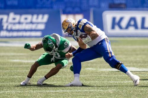 BROOK JONES/FREE PRESS Winnipeg Blue Bombers quarterback Chris Streveler (No. 17) runs with the football while Riders defensive back Marcus Sayles (No. 8) stops his progression during second quarter action on Saturday.