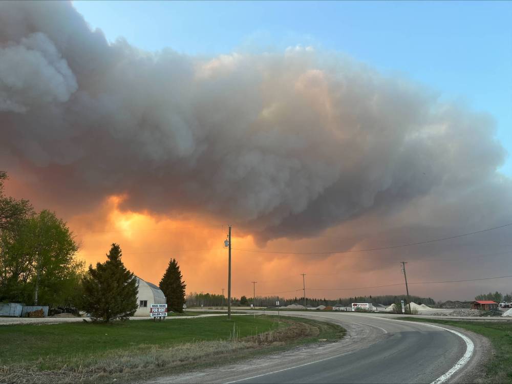 SUPPLIED
                                The view heading out of Pointe du Bois toward provincial road 313 as residents evacuated their cottages May 13.