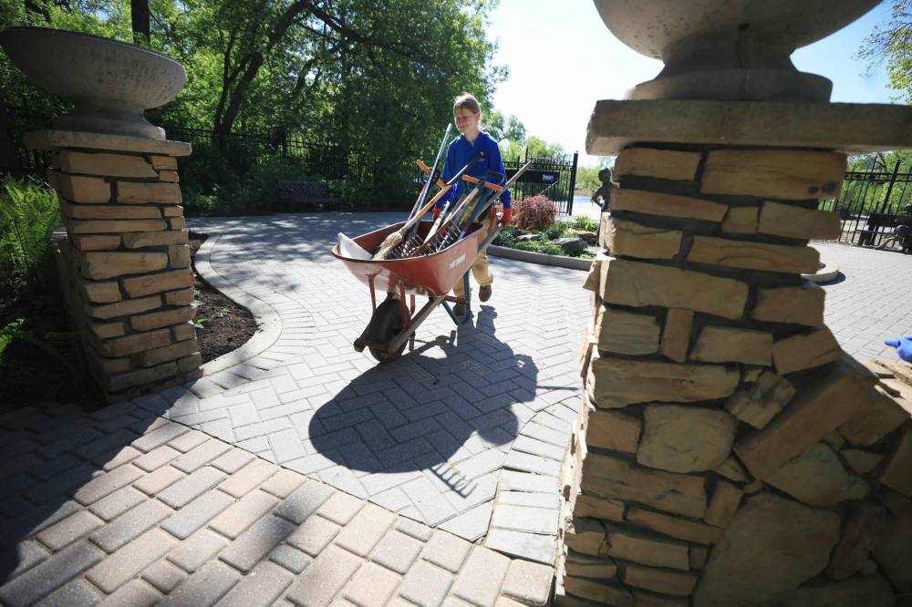 Ruth Bonneville / Free Press
U of M student Sarah Lawton manoeuvres a wheelbarrow filled with gardening tools.