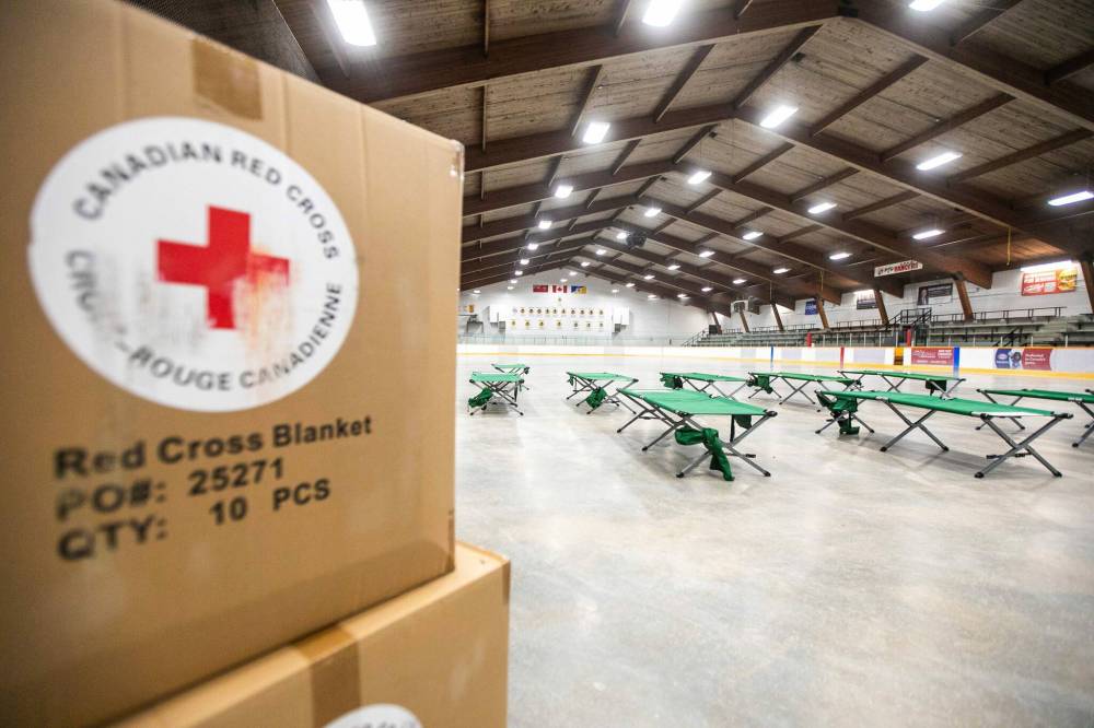 MIKAELA MACKENZIE / FREE PRESS
                                Cots set up in the empty hockey rink at Eric Coy Arena on Thursday await evacuees.