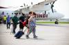 Evacuees from Pukatawagan get off of a plane in Winnipeg on Thursday. (Mikaela MacKenzie/Winnipeg Free Press)