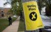 A sign marking a polling station is seen as a pedestrian walks past in Halifax on Nova Scotia's provincial election day on Tuesday, May 30, 2017. THE CANADIAN PRESS/Darren Calabrese