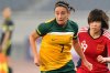 FILE - In this photo released by China's Xinhua news agency, Australia's Heather Garriock (7) vies with China's Zhou Feifei during their qualifying match of the 2012 Olympic women's soccer tournament in Jinan, China, Thursday, Sept. 8, 2011. (AP Photo/Xinhua, Xu Suhui, File)