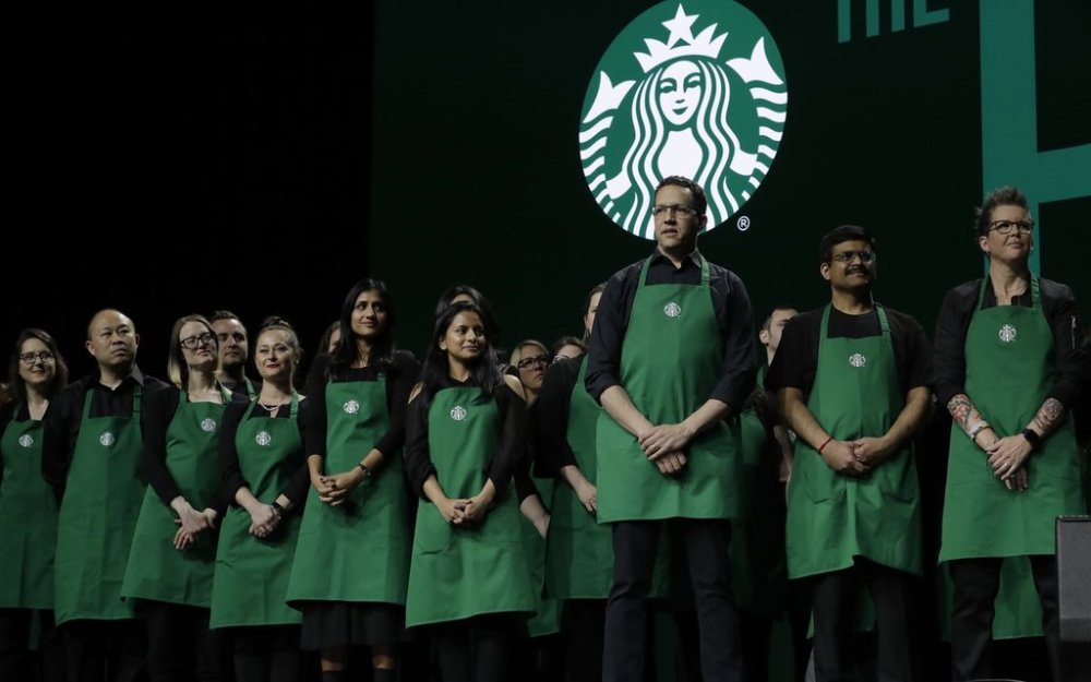 FILE - Starbucks baristas stand on stage, March 20, 2019, during an annual shareholders meeting in Seattle. (AP Photo/Ted S. Warren, file)
