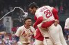 St. Louis Cardinals' Nolan Arenado (28) is congratulated by teammates after hitting a walk-off single to defeat the Los Angeles Dodgers in a baseball game Saturday, June 7, 2025, in St. Louis. (AP Photo/Jeff Roberson)