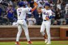 New York Mets' Jared Young (29) high fives Brett Baty (7) after his first home run of the season during the first inning against the Chicago White Sox, Tuesday, May 27, 2025, in New York. Baty scored on Young's home run. (AP Photo/Angelina Katsanis)