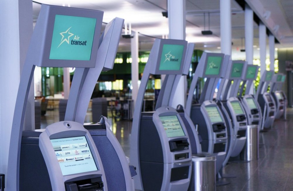Air Transat self service check-in kiosks are seen at Montreal-Trudeau International Airport in Montreal, on Friday, July 31, 2020. THE CANADIAN PRESS/Paul Chiasson