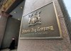 A women leaves the downtown Toronto flagship Hudson Bay Company store in Toronto on Monday, January 27, 2014. THE CANADIAN PRESS/Nathan Denette