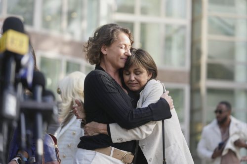 Anamaria Baralt, left, cousin of Erik and Lyle Menendez, left, gets a hug as she leaves the courthouse after the brothers' resentencing hearing Tuesday, May 13, 2025, in Los Angeles. (AP Photo/Damian Dovarganes)