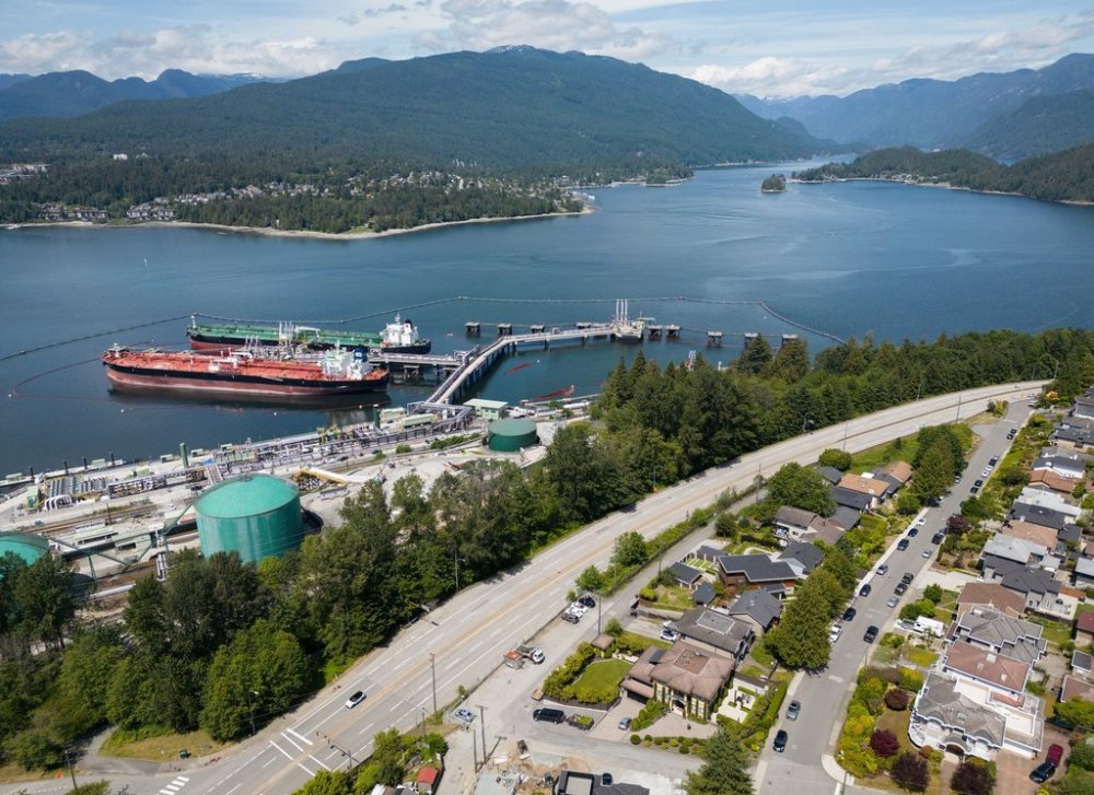Crude oil tankers SFL Sabine, front left, and Tarbet Spirit are seen docked at the Trans Mountain Westridge Marine Terminal, where crude oil from the expanded Trans Mountain Pipeline is loaded onto tankers, near a residential area in Burnaby, B.C., Monday, June 10, 2024. THE CANADIAN PRESS/Darryl Dyck