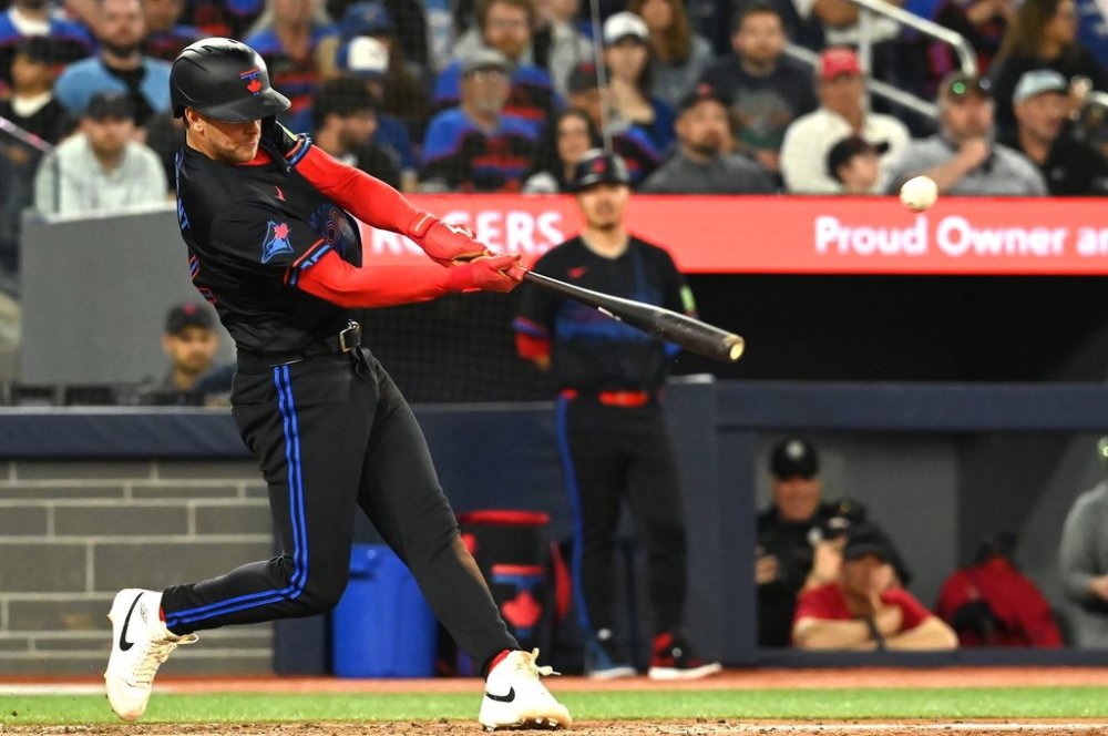 Blue Jays infielder Ernie Clement (22) hits a single against the Athletics in the seventh inning of a Major League Baseball game in Toronto on Friday, May 30, 2025. THE CANADIAN PRESS/Jon Blacker