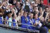 Chelsea's Millie Bright, center, lifts the trophy with teammates following victory in the English Women's FA Cup Final soccer match against Manchester United at Wembley Stadium, London, Sunday, May 18, 2025. (John Walton/PA via AP)