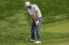 Scottie Scheffler chips onto the fourth green during the final round of the Memorial golf tournament Sunday, June 1, 2025, in Dublin, Ohio. (AP Photo/Sue Ogrocki)