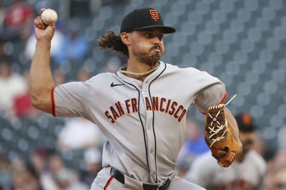 San Francisco Giants pitcher Jordan Hicks (12) throws to the Minnesota Twins during the first inning of a baseball game Friday, May 9, 2025, in Minneapolis. (AP Photo/Ellen Schmidt)