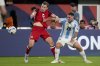 Canada's Alistair Johnston, left, and Argentina's Alexis Mac Allister battle for the ball during a Copa America semifinal soccer match in East Rutherford, N.J., Tuesday, July 9, 2024. (AP Photo/Pamela Smith)