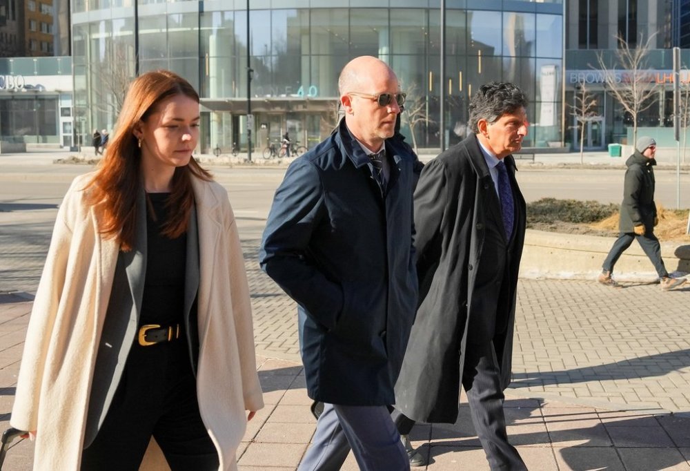 Jeffrey Wood, centre, arrives at the Ottawa courthouse alongside Lawrence Greenspon, right, and Hannah Drennan for a hearing in Ottawa, on Friday, March 14, 2025. THE CANADIAN PRESS/Chris Tanouye