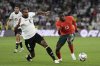 Germany's Jonathan Tah, left, challenges for the ball with Portugal's Nuno Mendes during the Nations League semifinal soccer match between Portugal and Germany at the Munich Football Arena, in Munich, Germany, Wednesday, June 4, 2025. (AP Photo/Matthias Schrader)