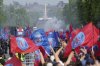 Supporters cheer PSG players during a parade on the Champs-Elysee avenue after the team won the Champions League final soccer match between Paris Saint-Germain and Inter Milan Sunday, June 1, 2025 in Paris. (AP Photo/Aurelien Morissard)