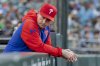 Philadelphia Phillies manager Rob Thomson looks to the dugout before a baseball game against the Athletics Saturday, May 24, 2025, in West Sacramento, Calif. (AP Photo/Sara Nevis)
