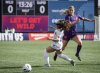 Ottawa Rapid's Jazmine Wilkinson, left, blocks Calgary Wild's Grace Stordy during first half Northern Super League soccer action in the in Calgary, on Sunday, May 11, 2025.THE CANADIAN PRESS/Jeff McIntosh