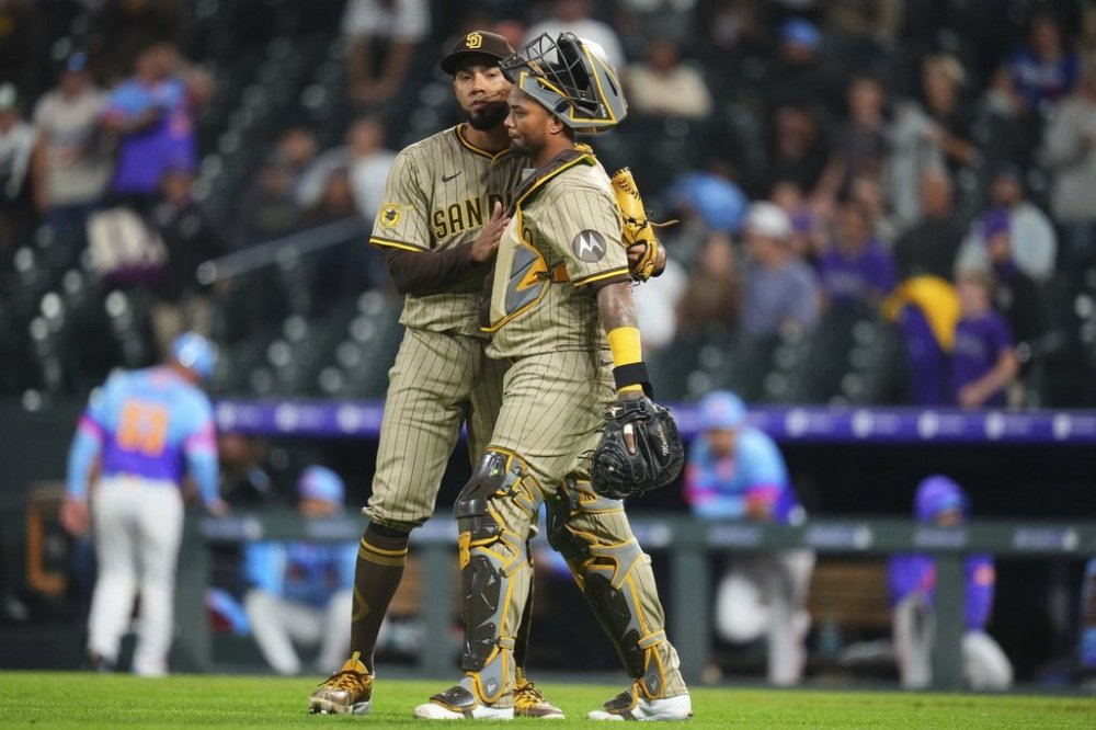 San Diego Padres closing pitcher Robert Suarez celebrates a win against the Colorado Rockies with catcher Martín Maldonado (15) following the ninth inning of a baseball game Friday, May 9, 2025, in Denver. (AP Photo/Jack Dempsey)