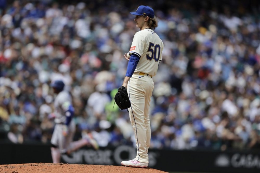 Seattle Mariners starting pitcher Bryce Miller (50) stands on the mound as Toronto Blue Jays' George Springer, back left, rounds the bases after hitting a three-run home run during the fifth inning of a baseball game Sunday, May 11, 2025, in Seattle. (AP Photo/John Froschauer)