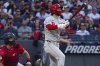 Philadelphia Phillies' Bryce Harper, right, watches his two-run home run off Cleveland Guardians relief pitcher Joey Cantillo as Guardians catcher Austin Hedges, left, looks on during the eighth inning of a baseball game Saturday, May 10, 2025, in Cleveland. (AP Photo/Phil Long)