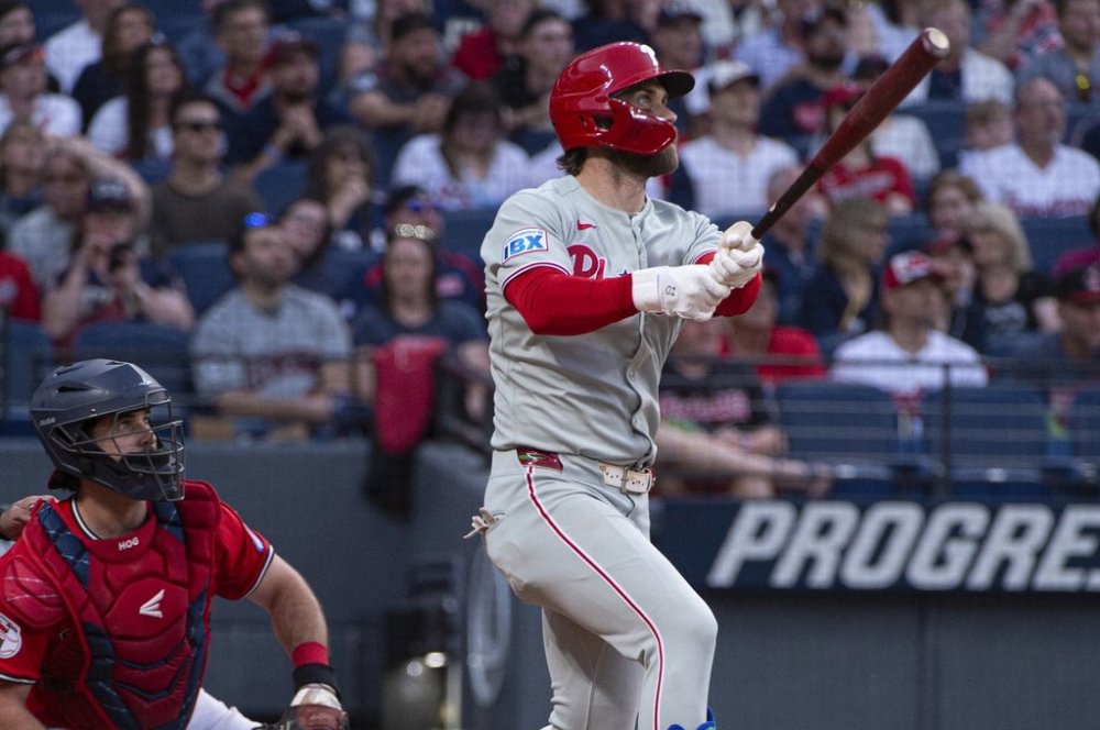 Philadelphia Phillies' Bryce Harper, right, watches his two-run home run off Cleveland Guardians relief pitcher Joey Cantillo as Guardians catcher Austin Hedges, left, looks on during the eighth inning of a baseball game Saturday, May 10, 2025, in Cleveland. (AP Photo/Phil Long)