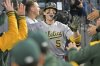 Athletics Jacob Wilson is congratulated in the dugout after hitting a 3-run home run during the third inning of a baseball game against the Los Angeles Dodgers, May 13, 2025, in Los Angeles. (AP Photo/Jayne Kamin-Oncea)