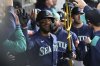Seattle Mariners' Julio Rodríguez celebrates with teammates in the dugout after hitting a grand slam during the eighth inning of a baseball game against the Chicago White Sox in Chicago, Monday, May 19, 2025. (AP Photo/Nam Y. Huh)
