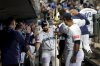 Seattle Mariners designated hitter Cal Raleigh, center, celebrates in the dugout after hitting a two-run home run during the third inning of a baseball game against the Minnesota Twins, Saturday, May 31, 2025, in Seattle. (AP Photo/Ryan Sun)