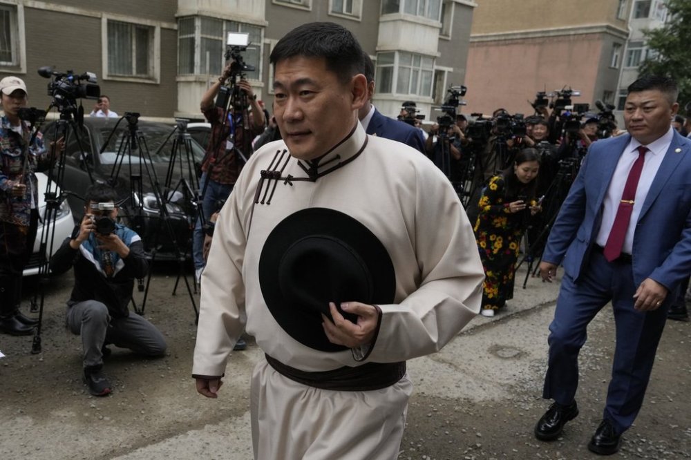 FILE -Mongolian Prime Minister Oyun-Erdene Luvsannamsrai walks past journalists as he arrives to vote at a polling station in Ulaanbataar, Mongolia, June 28, 2024. (AP Photo/Ng Han Guan, File)
