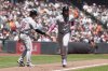 Arizona Diamondbacks' Ketel Marte, right, is congratulated by third base coach Shaun Larkin (88) after hitting a two-run home run during the fourth inning of a baseball game against the San Francisco Giants in San Francisco, Wednesday, May 14, 2025. (AP Photo/Jeff Chiu)