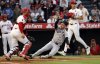 New York Yankees' Cody Bellinger, center, slides to score with Los Angeles Angels catcher Logan O'Hoppe, front left, at home plate on a three-run double by teammate Anthony Volpe during the fourth inning of a baseball game Monday, May 26, 2025, in Anaheim, Calif. (AP Photo/Kevork Djansezian)
