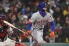 New York Mets' Brett Baty watches his single in the fifth inning of a baseball game against the Boston Red Sox at Fenway Park, Wednesday, May 21, 2025, in Boston. (AP Photo/Charles Krupa)