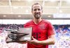 Bayern's Harry Kane stands on the pitch after the game with the top scorer of the 2024/2025 season award, after the German Bundesliga soccer match between TSG 1899 Hoffenheim and Bayern Munich at the PreZero Arena in Sinsheim, Germany, Saturday, May 17, 2025. (Uwe Anspach/dpa via AP)