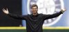 FILE - Former Seattle Mariners pitcher Randy Johnson acknowledges an ovation from the fans as he walks onto the field for the ceremonial first pitch before the Mariners' baseball game against the Oakland Athletics on April 12, 2010, in Seattle. (AP Photo/Elaine Thompson, file)
